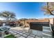 Spacious backyard with hot tub, patio furniture, and mountain views at 5859 Noble Stand St, Las Vegas, NV 89148