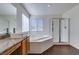 Spa-like bathroom with soaking tub, walk-in shower, and modern vanity at 5859 Noble Stand St, Las Vegas, NV 89148