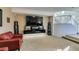 Living room with large TV, fireplace, and built-in shelving at 5859 Noble Stand St, Las Vegas, NV 89148
