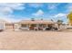 Backyard view of home with covered patio and large gravel area at 6168 Isthmus Cir, Las Vegas, NV 89110