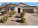 Two-story home with a brick walkway and landscaping at 6220 Cotinga St, North Las Vegas, NV 89031