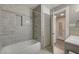 Bright bathroom with white tiled shower, tub, and convenient storage cabinets at 632 Avenue D, Boulder City, NV 89005