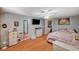 Relaxing bedroom with wood laminate floors, a ceiling fan, and decorative accents on the walls at 632 Avenue D, Boulder City, NV 89005