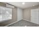 The bedroom includes soft gray carpet, a large window, and built in storage space at 632 Avenue D, Boulder City, NV 89005