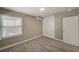 This cozy carpeted bedroom features a built-in wardrobe/cabinet, a window, and neutral paint at 632 Avenue D, Boulder City, NV 89005