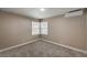 Comfortable bedroom featuring plush carpeting, a bright window, and neutral walls at 632 Avenue D, Boulder City, NV 89005
