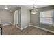 Well-lit dining area with wood-look flooring, modern lighting fixture, and window at 632 Avenue D, Boulder City, NV 89005