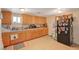 Functional kitchen showcasing wooden cabinets, a double sink, and a black refrigerator adorned with magnets at 632 Avenue D, Boulder City, NV 89005