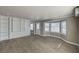 Bright and open living room with wood-look floors, built-in shelving, and lots of windows at 632 Avenue D, Boulder City, NV 89005