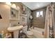 Bathroom with shower and tub, tiled wall and pedestal sink at 632 D, Boulder City, NV 89005