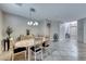 Dining room with oval table and modern light fixture at 7286 Laramie Ave, Las Vegas, NV 89113