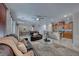 Open living area with leather sofas and a kitchen at 7286 Laramie Ave, Las Vegas, NV 89113