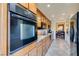 Galley kitchen with granite countertops, wood cabinets, and black appliances at 730 S Royal Crest Cir # 426, Las Vegas, NV 89169