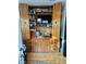 Built-in wooden cabinet with TV, shelves, and storage at 738 Tam O Shanter, Las Vegas, NV 89109