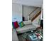 Living room with sectional sofa, coffee table, and a view of the staircase at 738 Tam O Shanter, Las Vegas, NV 89109