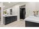 Modern bathroom with dark cabinetry and dual sinks at 7869 Wheeler Creek Ct, Las Vegas, NV 89113