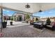 Covered patio with seating area, adjacent to the pool at 7869 Wheeler Creek Ct, Las Vegas, NV 89113