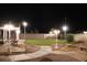 Landscaped backyard with lighting and a putting green at 830 Park Ln, Henderson, NV 89015