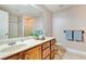Bathroom with double vanity, wood cabinets and a shower at 830 Park Ln, Henderson, NV 89015