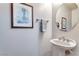 Clean and simple powder room with pedestal sink and framed artwork at 830 Park Ln, Henderson, NV 89015