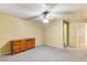 Well-lit bedroom with ceiling fan and carpet at 830 Park Ln, Henderson, NV 89015