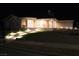 House exterior at night with landscape lighting at 830 Park Ln, Henderson, NV 89015