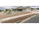 House exterior showcasing the front yard and driveway at 830 Park Ln, Henderson, NV 89015