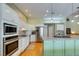 Modern kitchen featuring stainless steel appliances and a large island with seating at 830 Park Ln, Henderson, NV 89015