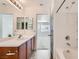 Bright bathroom featuring a vanity with mirror, bathtub, and doorway at 9140 Silk Threads Ave, Las Vegas, NV 89149