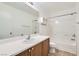 Well-lit bathroom with a white vanity, large mirror, and shower-tub combination at 9140 Silk Threads Ave, Las Vegas, NV 89149