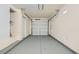 Clean, empty garage space with freshly painted floor and access door at 9140 Silk Threads Ave, Las Vegas, NV 89149