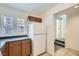 A clean, functional kitchen with a white refrigerator, wooden cabinets and tile floor at 9140 Silk Threads Ave, Las Vegas, NV 89149