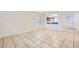 Large living area with tile floors opens to a well-lit kitchen with a breakfast bar for seamless entertaining at 9140 Silk Threads Ave, Las Vegas, NV 89149