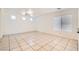 Bright living room boasts neutral walls, a large window and tile floors, creating an inviting and airy atmosphere at 9140 Silk Threads Ave, Las Vegas, NV 89149