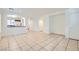 Spacious living room features neutral paint, tile flooring, and seamless flow into dining area and kitchen at 9140 Silk Threads Ave, Las Vegas, NV 89149