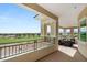 Expansive balcony with golf course views, comfortable seating, and elegant architectural details at 9145 Las Manaitas Ave # 401, Las Vegas, NV 89144