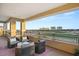 Covered balcony with seating area overlooking a golf course and city skyline at 9145 Las Manaitas Ave # 401, Las Vegas, NV 89144