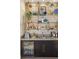 Stylish bar area with glass shelves and a beverage fridge at 9145 Las Manaitas Ave # 401, Las Vegas, NV 89144