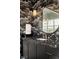 Modern bathroom vanity with black marble counters and decorative wallpaper at 9145 Las Manaitas Ave # 401, Las Vegas, NV 89144