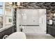 Shower in a modern bathroom with marble walls and black accents at 9145 Las Manaitas Ave # 401, Las Vegas, NV 89144