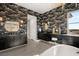 Modern bathroom with double vanity, sleek mirrors and a large soaking tub at 9145 Las Manaitas Ave # 401, Las Vegas, NV 89144