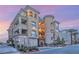 Elegant multi-story building with balconies, manicured landscaping and a stately entrance at 9145 Las Manaitas Ave # 401, Las Vegas, NV 89144