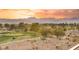 Scenic golf course view with lush green fairways and desert landscape against a colorful sunset sky at 9145 Las Manaitas Ave # 401, Las Vegas, NV 89144