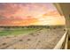 Sunset view from a balcony, showing a pristine golf course with mountains in the distance at 9145 Las Manaitas Ave # 401, Las Vegas, NV 89144