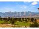 Stunning golf course view with mountains in the background and mature trees at 9145 Las Manaitas Ave # 401, Las Vegas, NV 89144