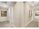 Hallway featuring neutral paint, modern light fixtures, contemporary artwork and tile and carpet flooring at 9145 Las Manaitas Ave # 401, Las Vegas, NV 89144