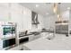 Contemporary kitchen boasts stainless steel appliances, modern white cabinetry, and a large island for cooking and entertaining at 9145 Las Manaitas Ave # 401, Las Vegas, NV 89144