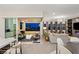 Bright living room showcases city views through sliding doors and an open-concept design with modern finishes and furnishings at 9145 Las Manaitas Ave # 401, Las Vegas, NV 89144