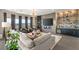 Bright living room with modern furniture, bar, large windows, and an electric fireplace at 9145 Las Manaitas Ave # 401, Las Vegas, NV 89144