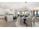 Open-concept living space with a modern kitchen, dining area, and balcony access at 9145 Las Manaitas Ave # 401, Las Vegas, NV 89144